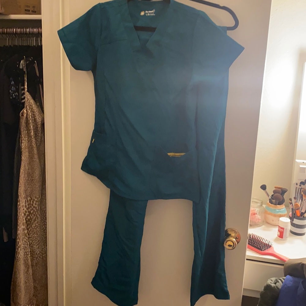 “Spread good cheer” branded scrubs . Hunter green
